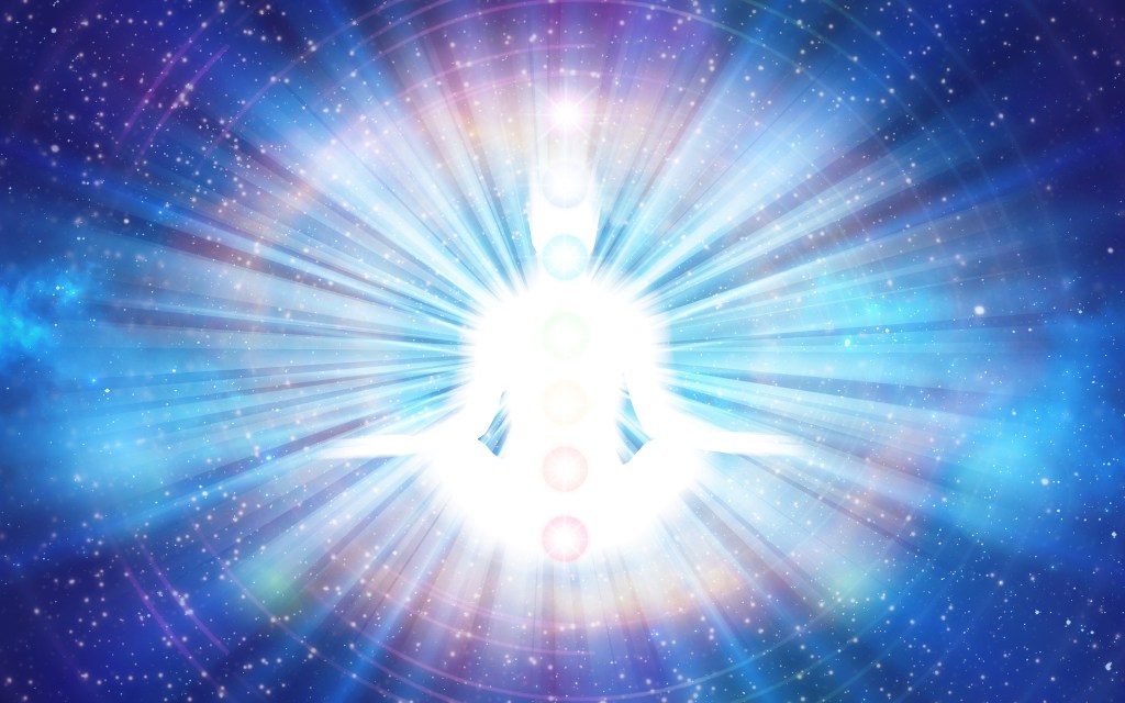 A glowing silhouette of a meditating figure surrounded by radiant light and colorful chakra symbols, set against a starry cosmic background.